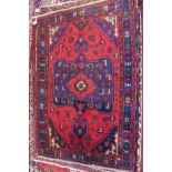 A fine North West Persian Mahal rug, central eagle motifs design on a rouge field within stylised