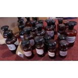 A collection of glass chemist's jars, comprising 11 large and 11 small, bearing descriptive
