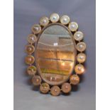 A Contemporary oval mirror, with circular mirrored border, having bevelled plate, 86 x 64cm