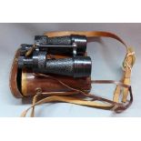 A pair of WWII Bino Prism No. 5 MK II x 7 field binoculars, 1943, in a leather carrying case