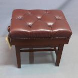 A piano stool, with brown leather button down upholstery