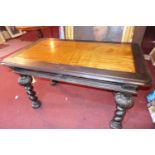 An early 20th century Continental ebonized table, with single drawer, raised on carved baluster