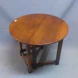 An early 20th century oak drop leaf cricket table