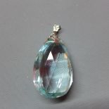 A large pear cut aquamarine pendant, in white metal and diamond set mount