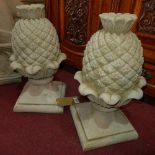 A pair of reconstituted stone pineapple finials on spreading bases, H.51cm (2)