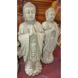 A pair of reconstituted stone statues of Buddha standing in prayer, on lotus bases, H.77cm