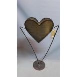 A wrought iron garden planter, with heart shape bowl