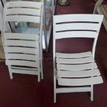 Two French white plastic folding chairs, (2)