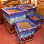 Two large blue and brown glazed planters, H.42 W.40 D.40cm, together with two smaller matching