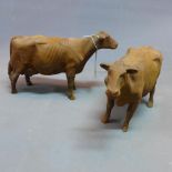 Two cast iron cows, H.26 W.37cm