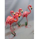 A set of four sheet metal flamingos