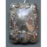 A Victorian silver cigarette case, repousse embossed with C-scrolls and flowers, having gilded