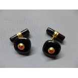 A pair of gilded white metal, black onyx and ruby inset cufflinks