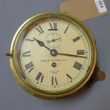 A Smith brass bulkhead clock, the dial with Roman numerals, seconds subsidiary dial at 12,