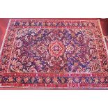 A fine Northwest Persian Bakhtiar carpet with a central medallion and floral design on a deep blue
