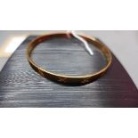 A 9ct rose gold bangle