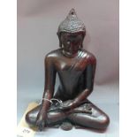 A resin model of seated Buddha, stamped 'The BM', H.33cm