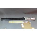 An ebony and silver page turner, the silver handle with C-scroll decoration and vacant cartouche,