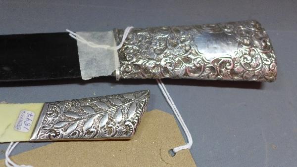An ebony and silver page turner, the silver handle with C-scroll decoration and vacant cartouche, - Image 2 of 2