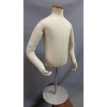 A late 20th century stuffed mannequin torso, raised on steel support