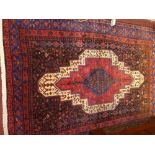 A fine North West Persian Senneh rug, central double pendent medallion on a midnight filed within