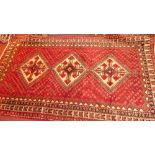 A fine South West Persian Abadeh carpet, 310cm x 175cm, containing triple lozenges on a rouge