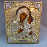 A Russian icon depicting The Mother of God and Christ, tempera on wood panel with gilt and enamel