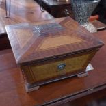 A Regency mahogany and walnut box of sarcophagus form with lion head handles raised on bracket