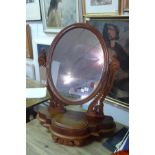 A Victorian carved mahogany swing toilet mirror on base.