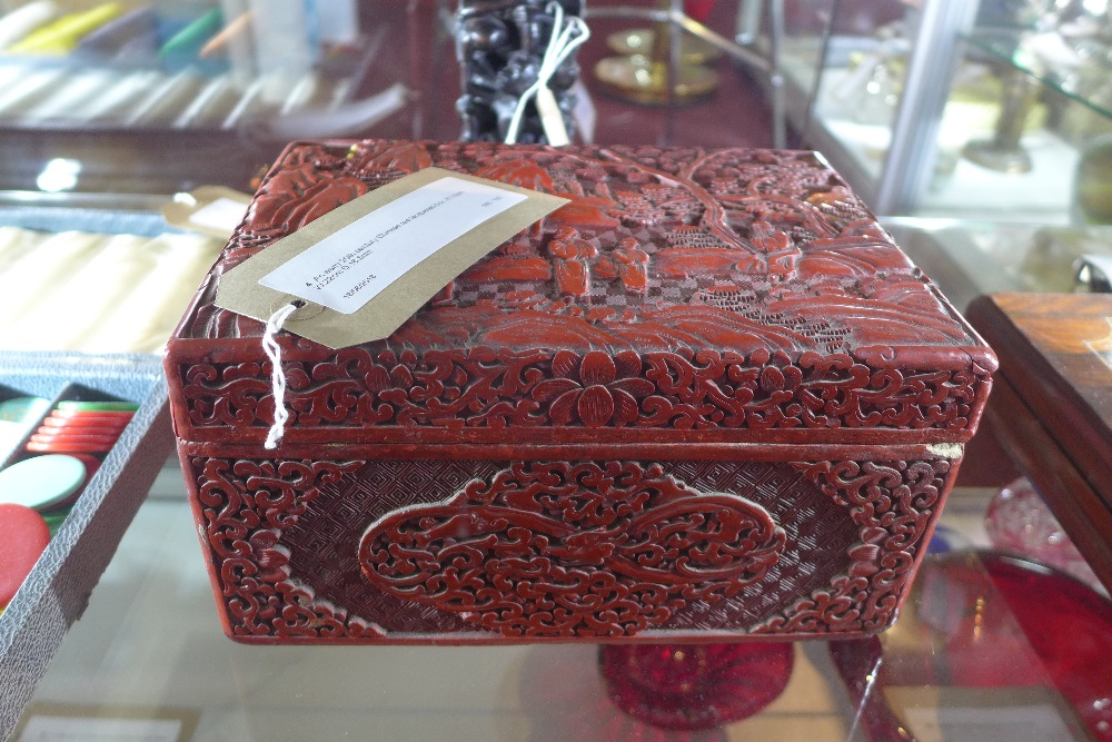 An early 20th century Chinese red lacquered box, H.12cm W.22cm D.16.5cm