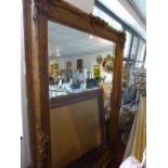 A large and decoratively framed gilt pier mirror in the rococo style H.218cm W.160cm