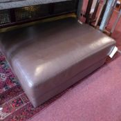 A contemporary brown leatherette ottoman, with rising hinge lid enclosing storage compartment