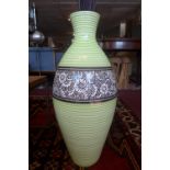 A contemporary ceramic baluster vase, with central floral decorated band on green and white