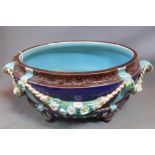 A Joseph Holdcroft Majolica Jardiniere, having twin head handles, decorated with swags, stamped to