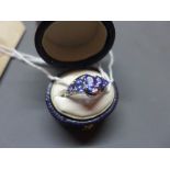 A 14ct white gold, tanzanite and diamond inset ring