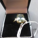 A ladies 9ct yellow gold green amethyst and diamond inset ring, stamped 9k