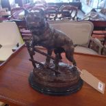 A cast bronze study of a Staffordshire bull terrier on a fence, on naturalistic base, signed C.