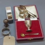 A collection of Victorian and later silver items to include spoons, napkin rings and egg cup