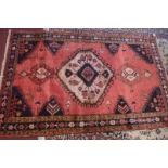A fine North West Persian Tafresh rug, central diamond medallion on a terracotta field guarded by
