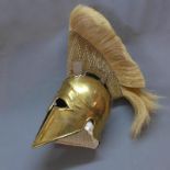 A reproduction brass Spartan helmet