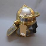 A reproduction brass Roman Centurion helmet
