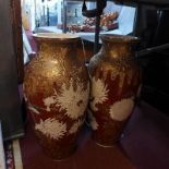 A large pair of 19th century Japanese satsuma vases, decorated with birds on a red and gilt