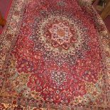 A Persian style carpet with central floral medallion on a red ground, with floral borders, 268 x