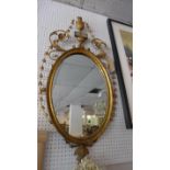 A 19th century oval giltwood pier mirror, with urn finial, 105x53cm