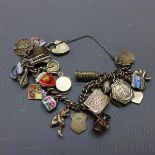A Continental white metal charm bracelet with assorted charms, the charms marked 800 and Silver
