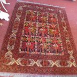 A hand woven Greek rug, with central geometric tile design, contained by geometric borders, on a red