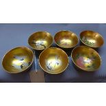 A set of six Chinese gold lacquered bowls depicting hand painted flora and fauna scenes.