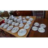 An extensive Limoges 'Hortense' blue and white dinner service to include 14 consomme soup bowls,