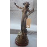 A late 19th century spelter figure of a maiden, playing a harp, signed