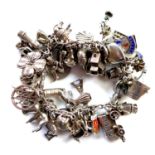 A vintage silver charm bracelet with 50 charms attached, approx. 90g